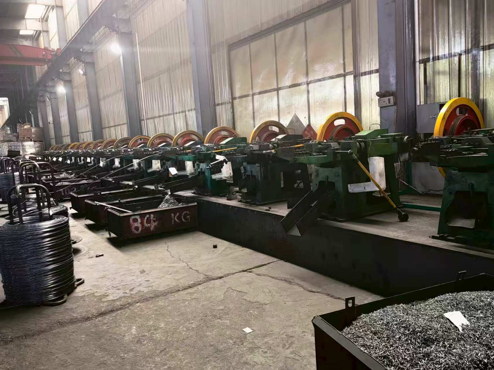 A full production line of automatic nail-forming machines working continuously