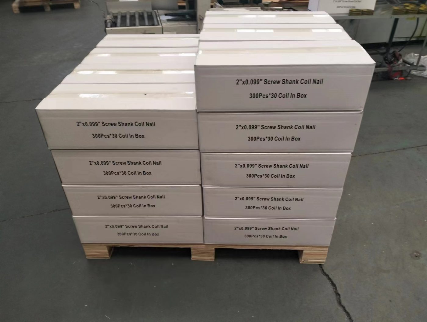 Cartons of 2-inch coil nails stacked on a wooden pallet