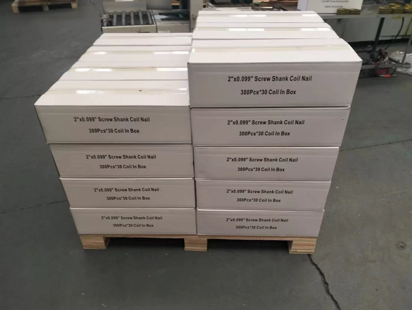 Cartons of 2-inch coil nails stacked on a wooden pallet